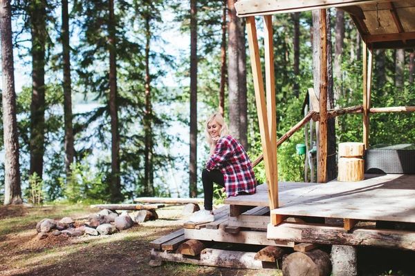 Girl sitting in a large tent in the woods