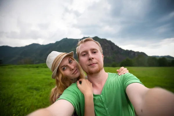 Portrait of couple on a background of mountains