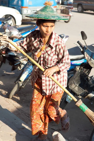 Women janitor cleans streets before start of  holiday in Myawaddy, Karen State, Myanmar