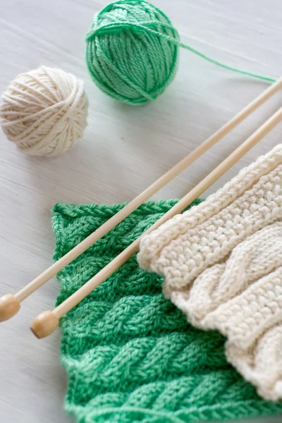 Two bright patterns and wooden knitting needles for a white back