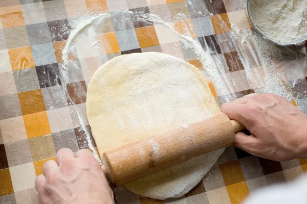 Sooking and home concept - close up of male hands kneading dough