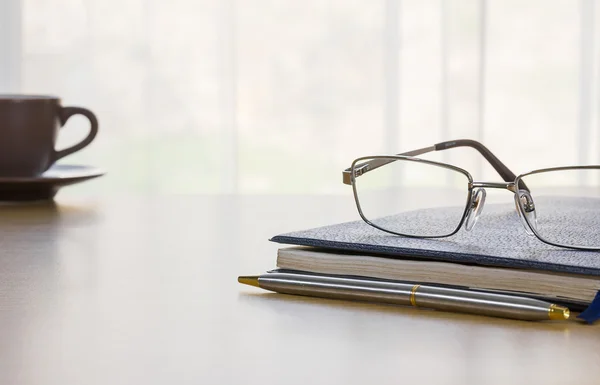 Glasses and book on the desk