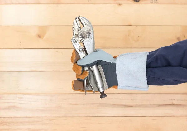 Hand in glove holding Adjustable wrench