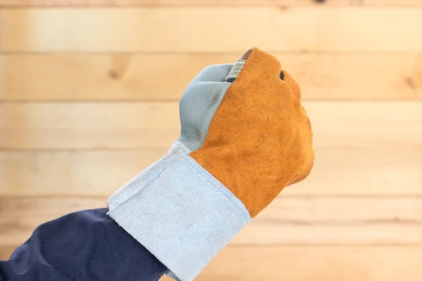 Hand in rough leather glove