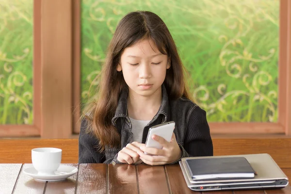 Asian young girl using mobile phone
