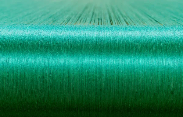 Green silk on a warping loom of a textile mill