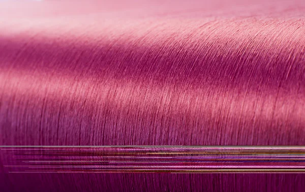 Green silk on a warping loom of a textile mill