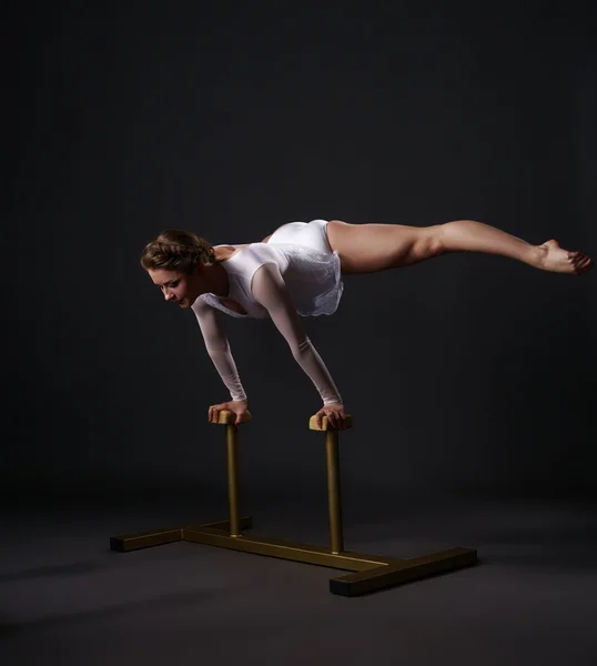 Beautiful acrobat training on circus stands