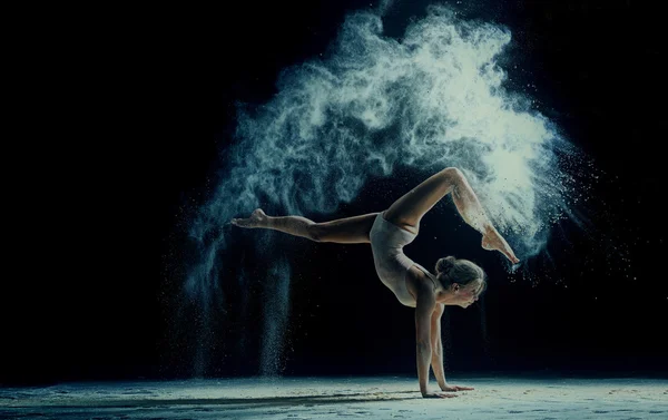 Graceful woman dancing in cloud of dust