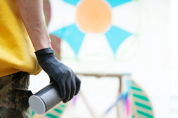 Graffiti artists hand with spray can, close-up