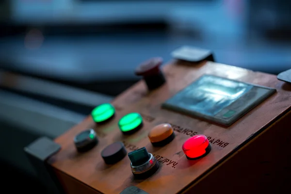 Close-up of red button lit on control panel