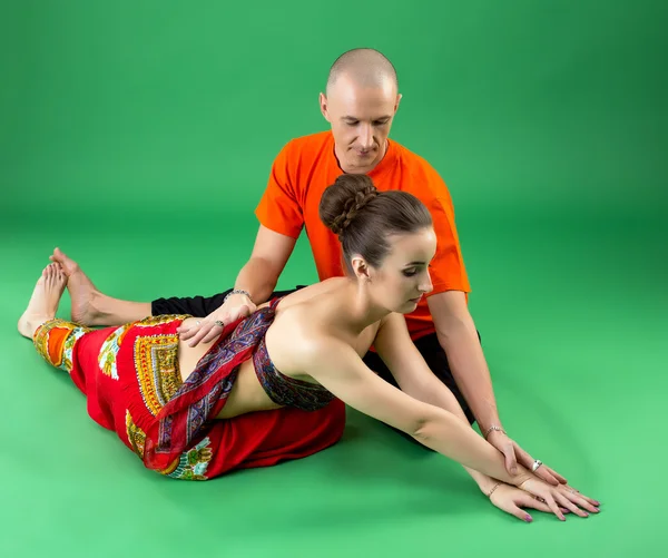 Yoga. Image of coach helps woman to perform asana