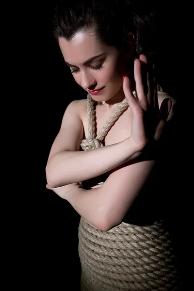 Kinbaku. Image of nude woman tied with jute rope