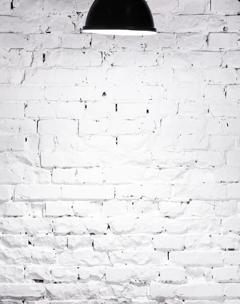 Texture of brick whitewashed wall with lamp on top