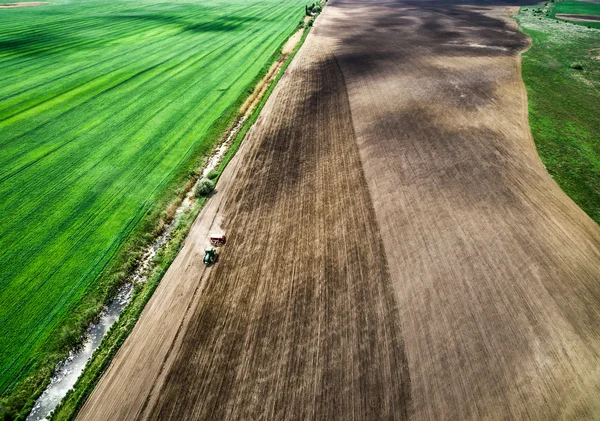 Harvester plowing field in spring