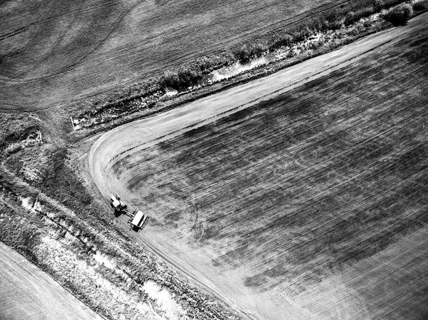 View from above on harvester plowing field