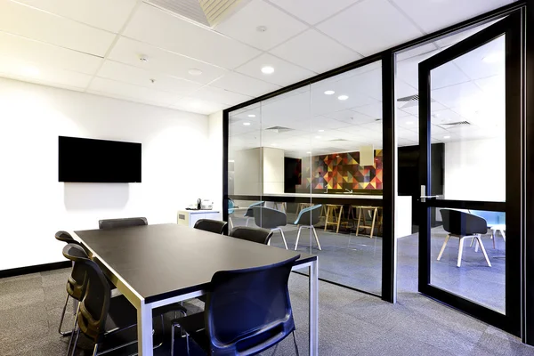 Conference room with black table with open glass door