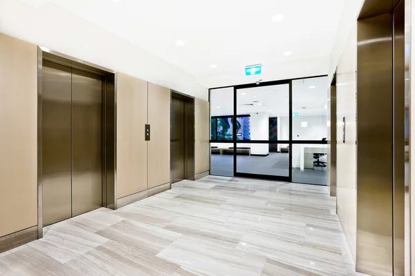 Silver elevator in a building with open door