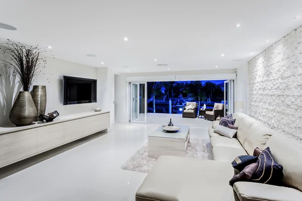 Modern living room at night with sofas and pillows
