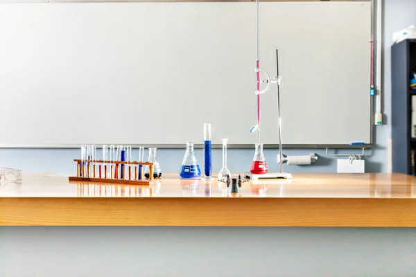 Laboratory items on the table with a white board