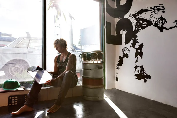 Girl and sits looks at a vinyl album in sunlight