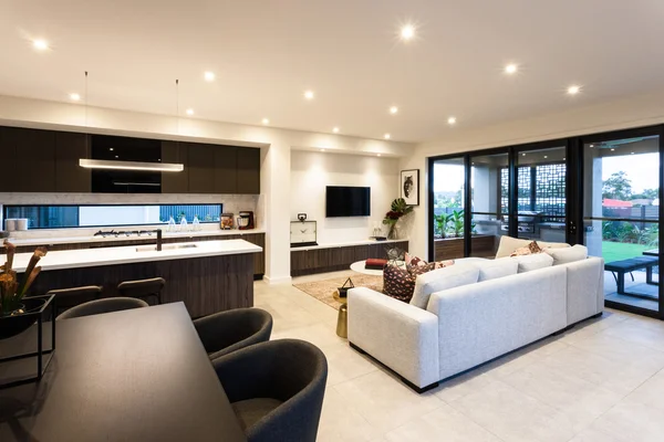 Modern living room and dining area beside patio area entrance