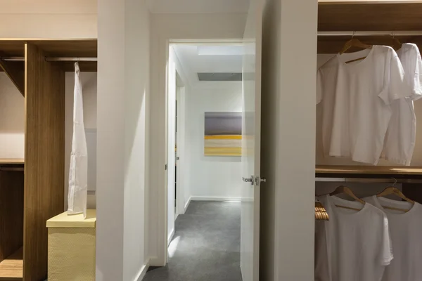 Laundry room of a modern house through the hallway