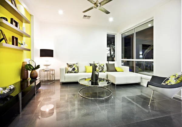 Living room with reflective tile floor and colorful decor