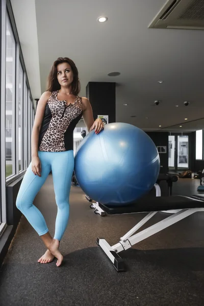 Girl leaning on a bouncy gym ball