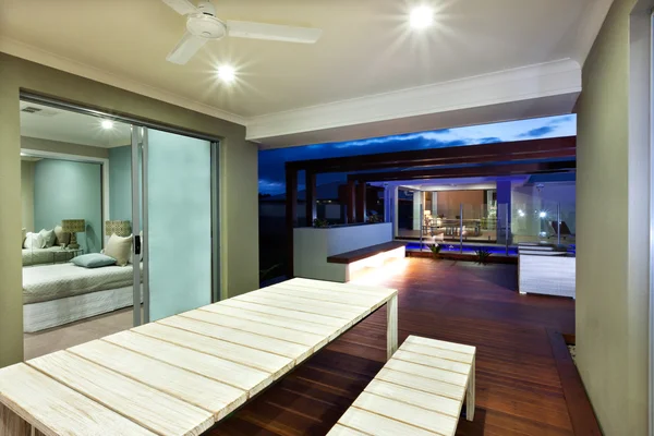 Interior ligting of a modern house with patio area at night