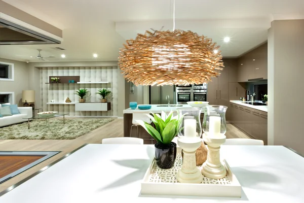 A flashing ceiling lamp hanging over the white table at night