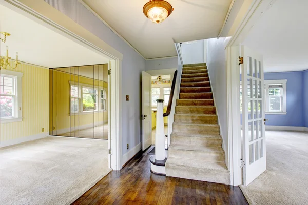 Simple entry way to home with carpet stairs.