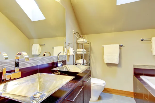 Modern bathroom interior with cherry wood cabinets, beige walls