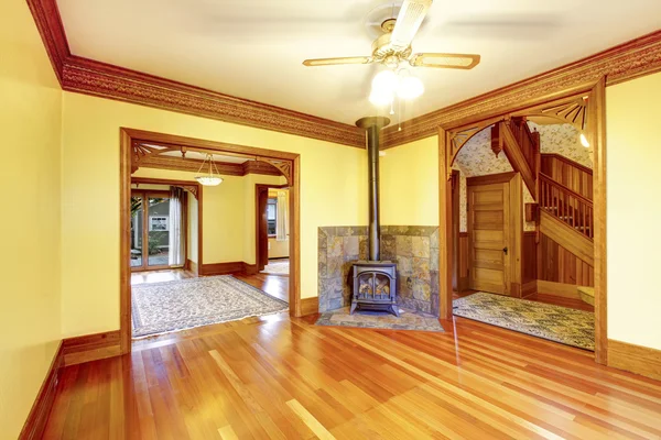 Unfurnished living room with fireplace, hardwood floor and yellow walls