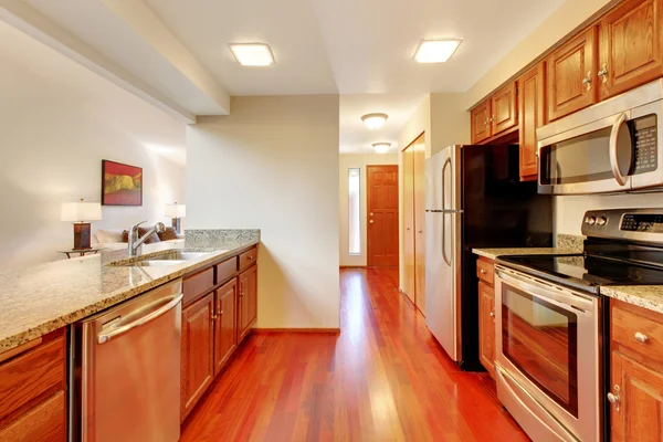 Clean style kitchen with wooden cabinets and granite counter tops.