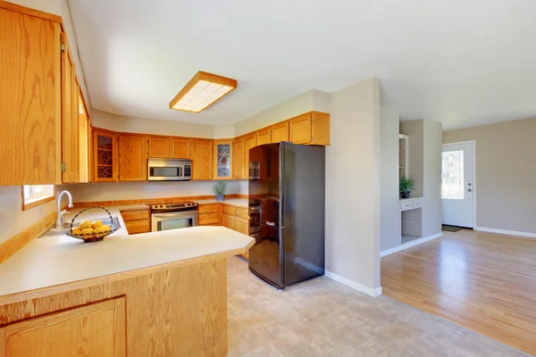 Bright wooden kitchen room interior designed in beige color.