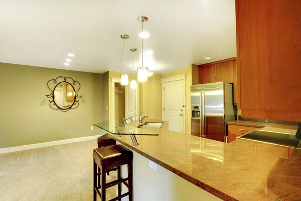 Bright kitchen room interior with granite counter top and breakfast bar.