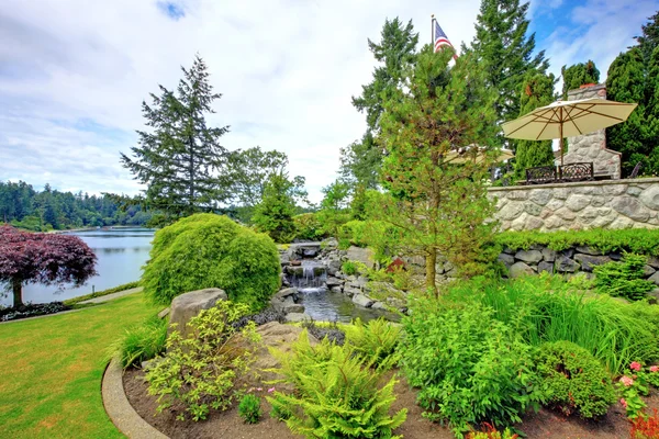 Backyard landscape with fountain and stone.