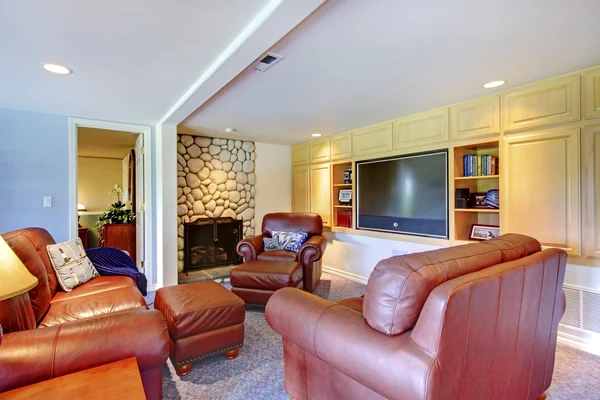 Classic cozy living room interior with fireplace and leather.