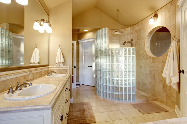 Antique bathroom design with glass shower and tile wall