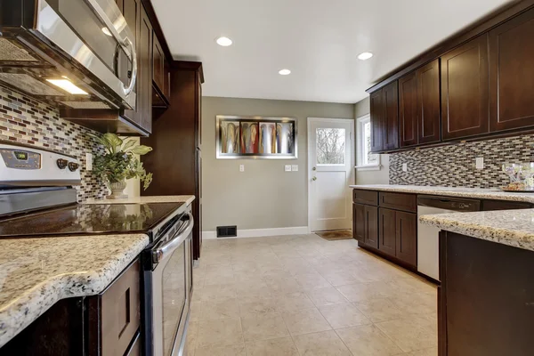 Modern kitchen interior with dark brown storage cabinets