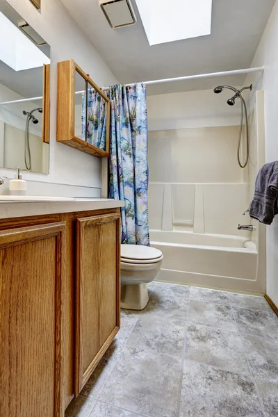 Bathroom with marble floor, toilet and wooden cabinet