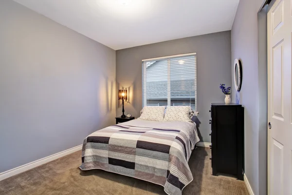 Gray simple bedroom with big bed, large window.