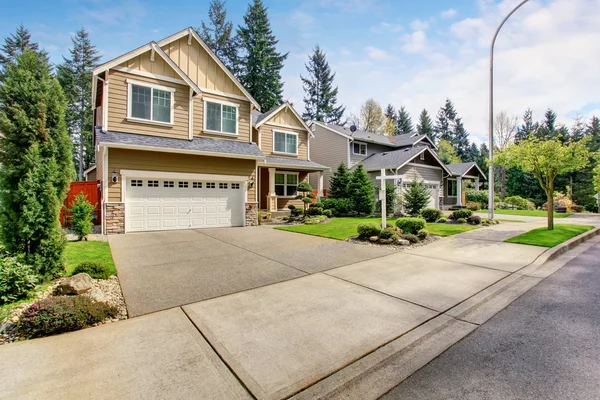 Nice curb appeal of American two story house with perfect landscape design.