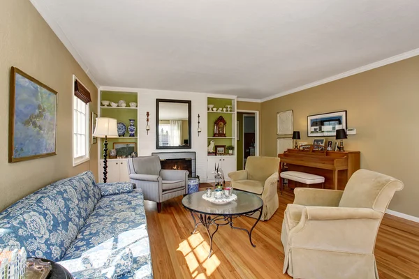 American living room interior with piano, classic sofa set and hardwood floor.