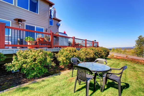 Spacious back yard with grass filled garden and amazing view.