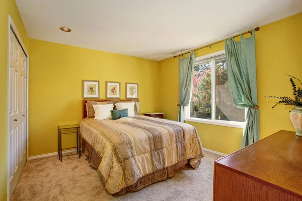Yellow and green bedroom interior with small bed and carpet floor.