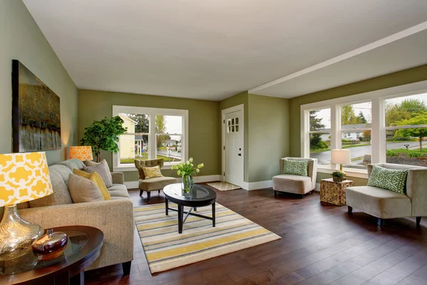 Living room interior with green walls hardwood floor and rug