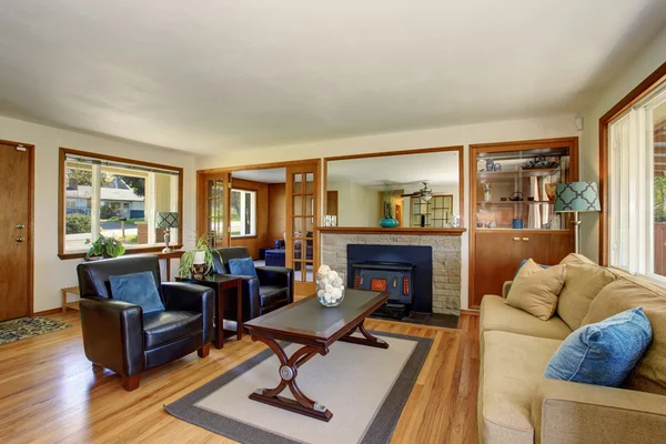 American classic Living room interior with black leather armchairs and fireplace.