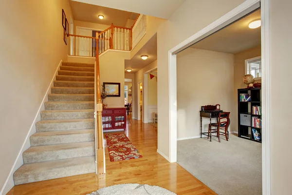 Calssic entry way with carpet floor stairs.